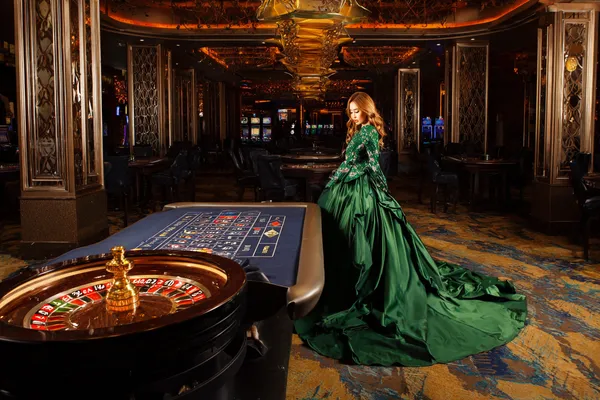 A young woman relaxing with her phone while dynamic casino elements float around her, illustrating the smooth mobile experience offered by the 777ZK app.